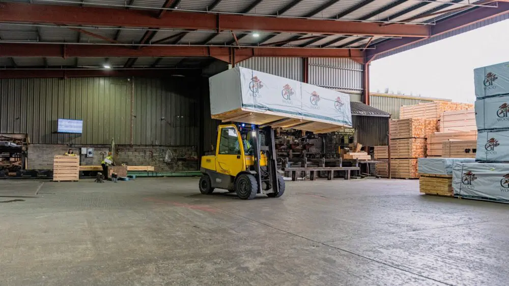 Forklift moving a wrapped timber pack in the GP Wood warehouse